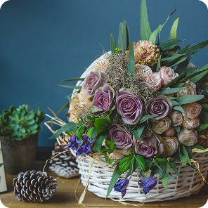 pastel_roses_greenery_in_a_woven_basket 